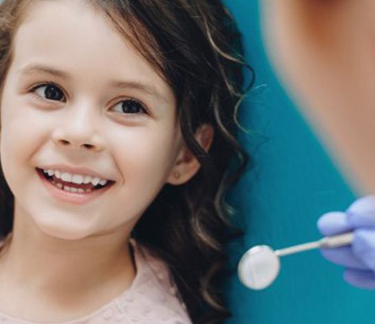 Girl smiling at her dentist