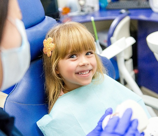 Girl smiling in the dental chair