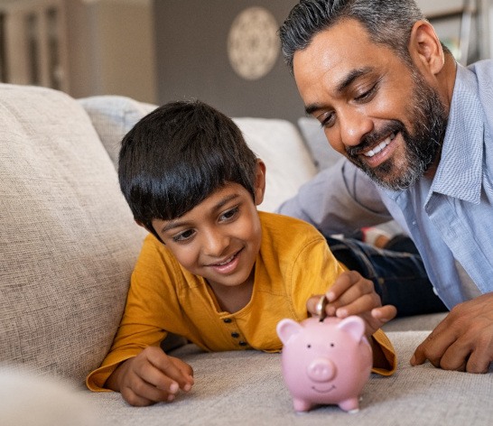 Child patient in Canton using a piggy bank for dental emergencies