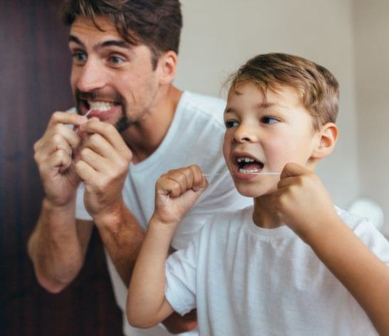 Patient in Canton brushing teeth with child to prevent dental emergencies