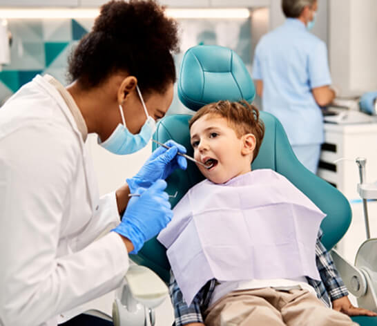 a dentist examining a child’s mouth